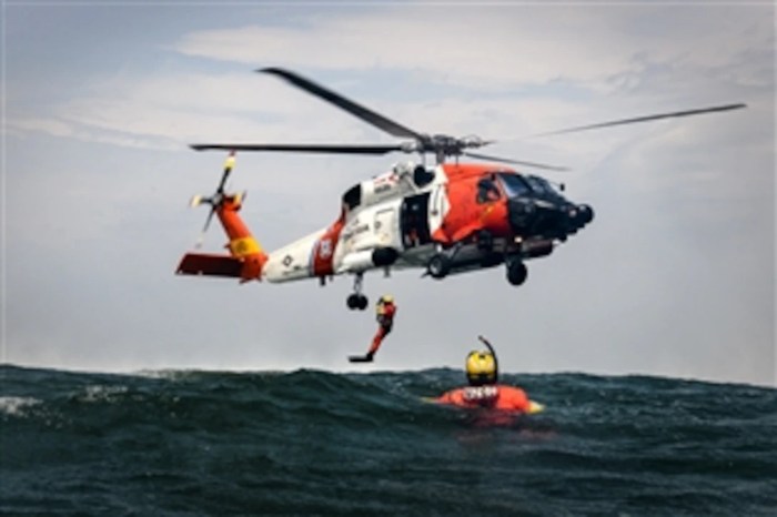 A rescue helicopter is lifting a man